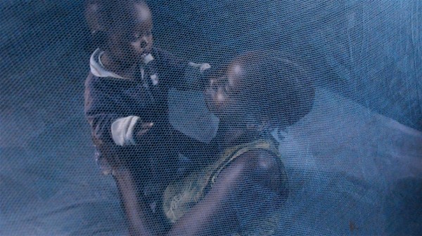 Mother and child under a mosquito net. Malaria. For generic use © Wendy Stone/IRIN 